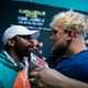 Floyd Mayweather (L) and Jake Paul pose during a press conference at Hard Rock Stadium, in Miami Gardens, Florida, on May 6, 2021.